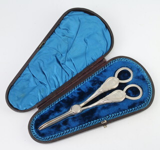 A pair of Victorian silver lily pattern grape scissors with engraved armorials Sheffield 1862, 134 grams, contained in a fitted case 