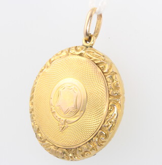 A 9ct yellow gold engine turned circular locket gross 3.9 grams 25mm 