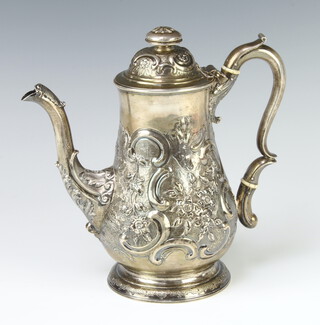 A George III baluster silver coffee pot with S scroll handle and floral finial, the repousse decoration with scrolls and flowers having a vacant cartouche, Newcastle 1740, 23cm, 786 grams 