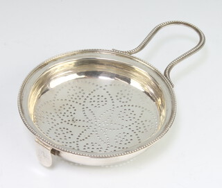 A George III silver lemon strainer with loop handle and now with side clip London 1783, 72 grams, 15cm, maker William Abdy