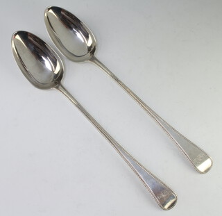 A pair of George III silver basting spoons with beaded decoration and armorials London 1811, 246 grams 