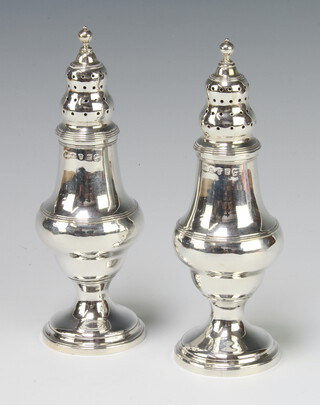 A pair of George III silver vase shaped peppers London 1801, 196 grams, 16cm 