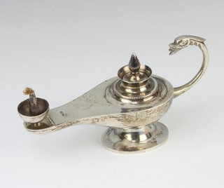 An Egyptian silver table oil lamp with serpent handle, 134 grams, 16cm 