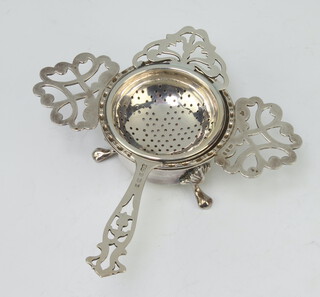 A silver tea strainer and stand London 1979, another tea strainer 144 grams 