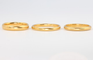 Three 22ct gold wedding bands size L, L 1/2 and P, 10.4 grams