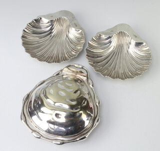 A pair of Edwardian silver shell butter dishes London 1908, 158 grams together with a plated ditto 