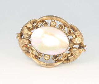A Victorian 9ct yellow gold scroll brooch mounted with a mother of pearl plaque 6.5cm Gross 24 grams