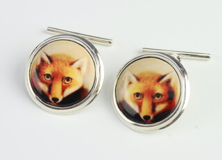 A pair of sterling silver cufflinks decorated with fox heads
