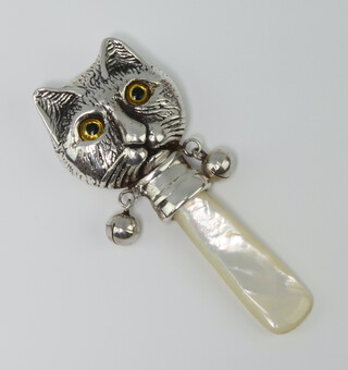 A Continental silver rattle in the form of a cats head with mother of pearl teether and glass eyes 7cm 