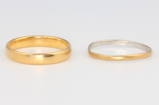 A platinum and 22ct gold wedding band 0.8 grams, size J 1/2 together with a 22ct gold wedding band 3.1 grams size L 1/2
