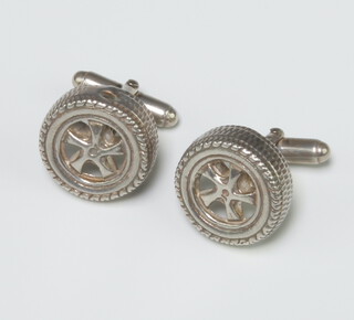 A pair of sterling silver cufflinks in the form of car wheels 13.5 grams 