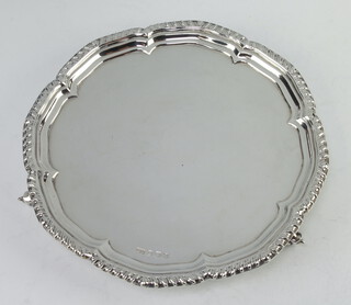 A silver salver with pie crust rim on scroll feet, Sheffield 1942, 21cm, 304 grams