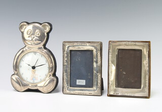 A pair of silver rectangular photograph frames 11cm x 8cm London 1985 and 1986 (both dented) together with a silver mounted bear timepiece 15cm 