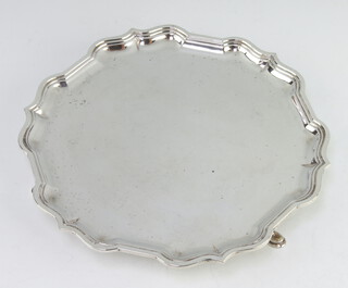 A silver card tray with Chippendale rim on hoof feet, Sheffield 1938, 20cm, 328 grams