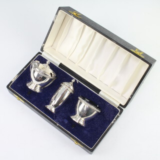 A silver 3 piece condiment set with strap work decoration London 1967, 154 grams, cased