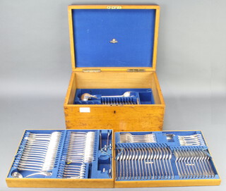 An Edwardian oak canteen containing silver plated lily pattern cutlery (106) 