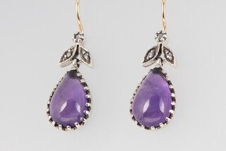 A pair of 9ct yellow gold and silver drop earrings set with cabochon cut amethysts and diamonds, 3.8 grams, 20mm