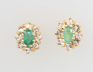 A pair of 18ct yellow gold oval emerald and diamond cluster earrings 18mm x 7mm, 3 grams
