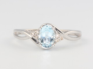 A 9ct white gold aquamarine and diamond ring, the centre oval aquamarine approx. 1ct, 1.6 grams, size R 