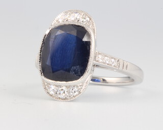 An 18ct white gold sapphire and diamond cocktail ring, the sapphire approx 5ct surrounded by brilliant cut diamonds approx. 0.28ct, size N, 6.7 grams