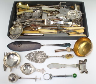 A silver plated tea strainer, minor plated cutlery 