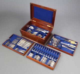 A part canteen of Edwardian silver plated cutlery with fancy handles in a bombe mahogany case