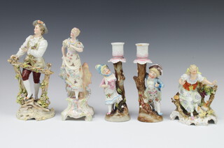 A German porcelain figure of a lady with chicken raised on a rococo base 13cm, a pair of ditto candlesticks with figural bases 16cm, a figure of a lady 21cm and a gentleman 21cm 