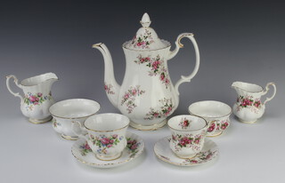 A Royal Albert Lavender Rose coffee set comprising coffee pot, 6 coffee cups, 6 saucers, milk jug, sugar bowl, together with a Royal Albert Moss Rose part tea set - 6 tea cups, 6 saucers, 6 small plates, 6 side plates, sandwich plate, sugar bowl and cream jug (a/f)