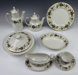 A Royal Doulton Larchmont dinner, tea and coffee service comprising 8 coffee cups, 8 saucers, 8 tea cups, 8 saucers, 8 two handled bowls, 8 soup bowls, sauce boat and stand, teapot, coffee pot, milk jug, cream jug, sugar bowl, serving plate, 2 oval meat plates, 8 small plates, 8 medium plates, 8 dinner plates, 2 tureens and covers, an oval vegetable dish