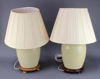 A pair of 20th Century Chinese crackle glazed table lamps of ovoid form 31cm x 20cm on hardwood bases 
