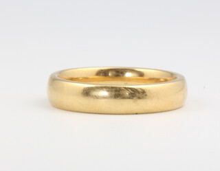 An 18ct yellow gold wedding band size K 1/2, 5.4 grams 