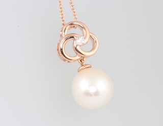 A 9ct rose gold natural pearl pendant set with diamonds on a 9ct rose gold chain, diamonds approx 0.04ct, 4.1 grams
