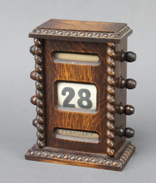 A 1920's perpetual calendar contained in an oak case with bead work decoration 16cm h x 12cm w x 6.5cm d