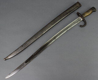An 1868 chassepot Yataghan sword bayonet complete with scabbard, back of the blade dated 1868 