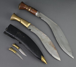 A Kukri with hardwood and brass grip 31cm together with a Kukri with brass grip 25cm with leather scabbard and skinning knife  