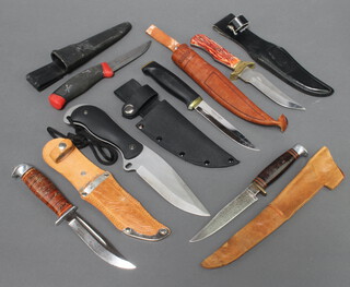 A Nokia skinning knife with leather scabbard, a Frost skinning knife, 3 Bowie knives with leather scabbards and a divers knife 
