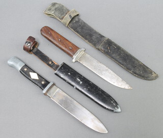 A German Whitby knife marked Whitby Made in Solingen with 13cm blade and complete with leather scabbard and 1 other knife with 12cm blade, wooden grip and leather scabbard 