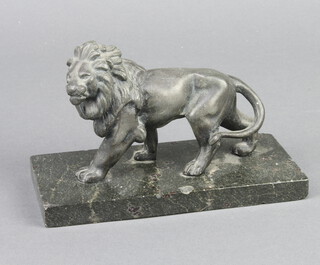 A 19th Century metal figure of a walking lion raised on a rectangular marble base 10cm h x 15.5cm w x 7.5cm d  
