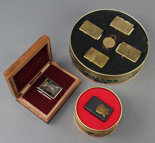 A Zippo D-Day 50th Anniversary Allied Heroes tin containing 3 lighters, a D-Day 50th Anniversary limited edition lighter in a metal tin and 1 other in a wooden box 