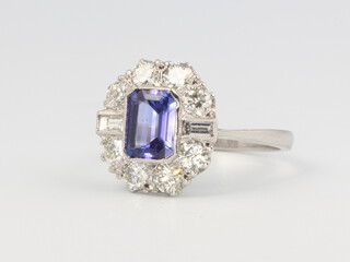 A platinum tanzanite and diamond cluster ring, the centre stone approx. 1.1ct, the brilliant and baguette cut diamonds approx. 1.3ct, size O, 5.3 grams