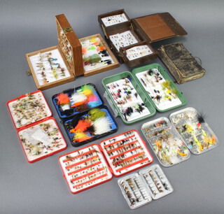 A Wheatley metal fly box containing a collection of fishing flies, 1 other fly box, a leather fly wallet containing flies, leather covered cantilever box containing a collection of flies, an Orvis fly box containing flies and 4 other fly boxes