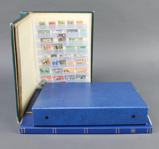 A green stock book of used GB and colonial stamps, a blue ring bind album of Elizabeth II mint and used stamps 1971-1982, blue stock book of GB mint and used stamps George VI to Elizabeth II  