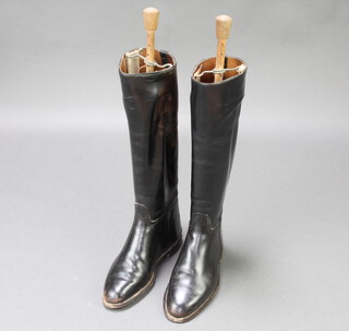 A pair of black leather riding boots complete with beech and metal sprung trees 