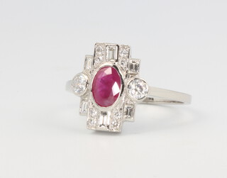 A platinum ruby and diamond cluster ring in the Edwardian style, the ruby approx. 0.65ct the brilliant and baguette cut diamonds approx. 1ct, size P, 4.3 grams 