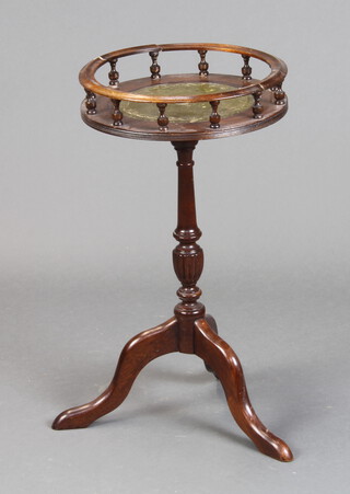 A circular Georgian style mahogany wine table with inset green leather top, galleried and bobbin turned decoration, raised on pillar and tripod support 55cm h x 30cm diam. (2 old breaks and repairs to the top) 