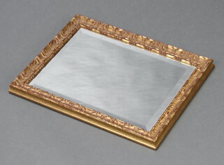 A rectangular plate wall mirror contained in a decorative gilt frame 47cm h x 37cm w 