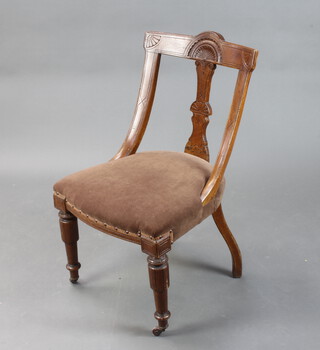 A late Victorian carved oak splat and bar back dining chair with overstuffed seat, on turned supports 