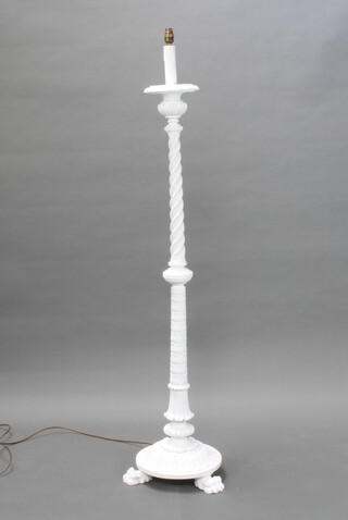 A Victorian style carved and white painted wooden standard lamp, raised on paw supports 150cm h 