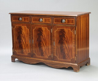 A Georgian style inlaid and crossbanded mahogany sideboard fitted 3 drawers above a triple cupboard, raised on bracket feet 80cm h x 121cm w x 45cm d 
