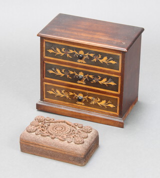 A rectangular Burmese carved hardwood cigarette box with hinged lid 7cm x 20cm x 11cm together with an inlaid mahogany 3 drawer table top chest 25cm h x 27cm w x 16cm d (some veneers missing from the drawers)